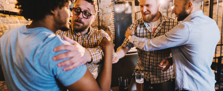 Group of drunk men starting a fight in pub.