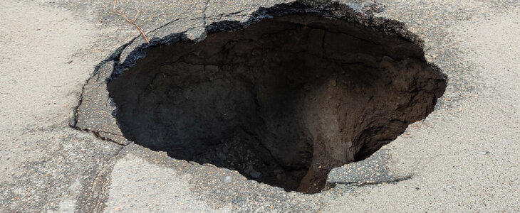 Large hole in the asphalt, a sinkhole