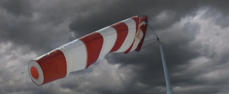 Attention storm warning! Windsock in front of an approaching thunderstorm front.